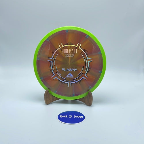 Front view of bronze Axiom Discs Fireball Distance Driver disc golf disc with silver stamp and neon green rim. It is made of Plasma Plastic and its flight numbers are 9, 3.5, 0, 3.5.