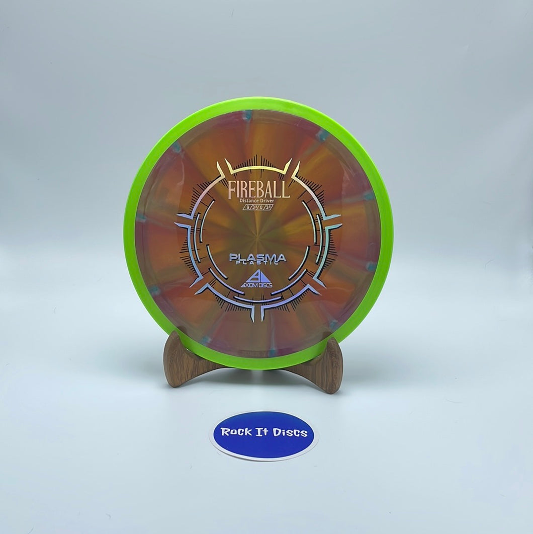 Front view of bronze Axiom Discs Fireball Distance Driver disc golf disc with silver stamp and neon green rim. It is made of Plasma Plastic and its flight numbers are 9, 3.5, 0, 3.5.